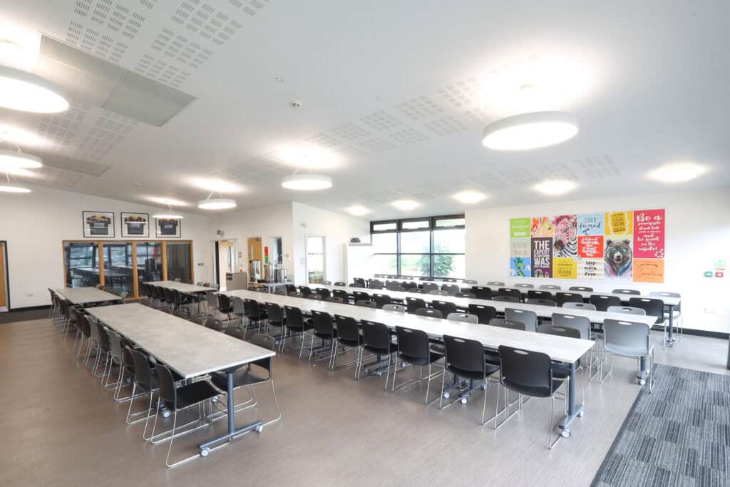 Wide shot of Stourport High School’s sixth form canteen featuring modern, space-saving canteen furniture in use.